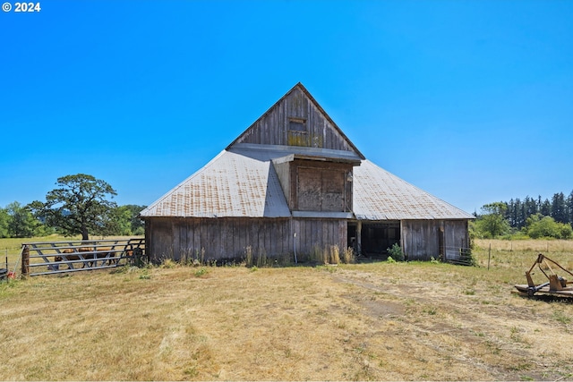 view of barn featuring fence