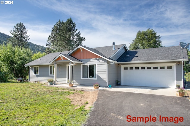 view of front facade featuring a front lawn and a garage