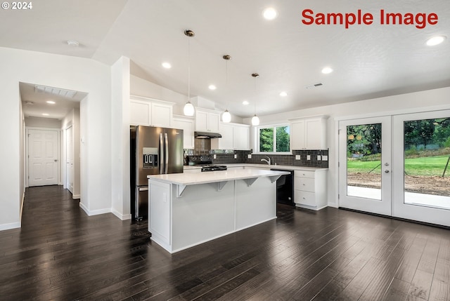 kitchen with dark hardwood / wood-style flooring, a kitchen island, black appliances, white cabinetry, and lofted ceiling