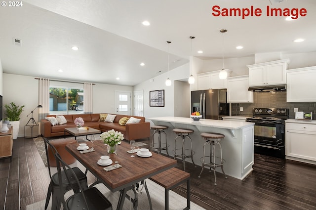 dining space featuring dark hardwood / wood-style flooring and lofted ceiling