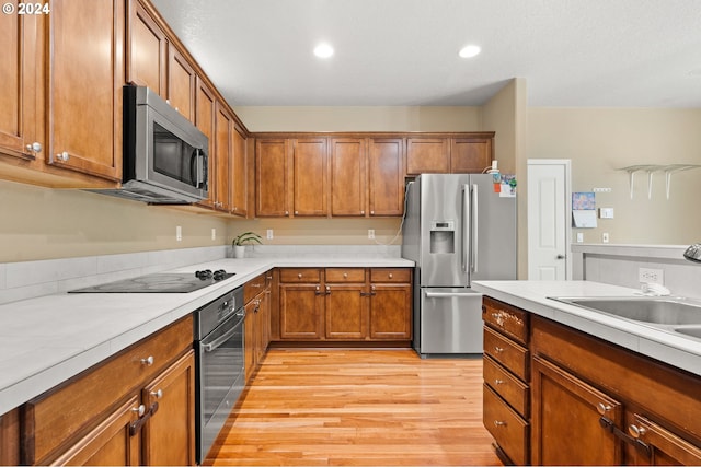 kitchen with light hardwood / wood-style flooring and stainless steel appliances