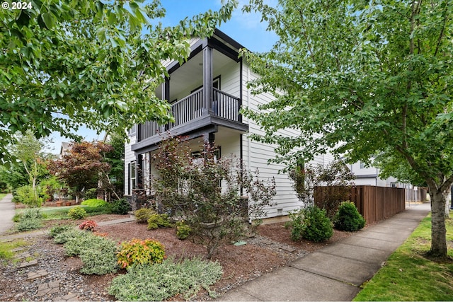 view of side of home featuring a balcony