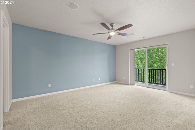 carpeted spare room with ceiling fan and a textured ceiling