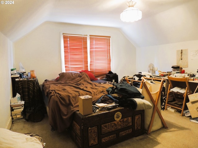 bedroom featuring carpet and vaulted ceiling