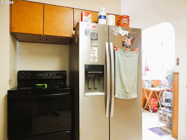 kitchen featuring stainless steel fridge and black electric range oven