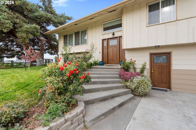 property entrance with a yard