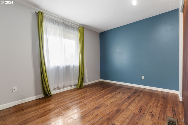 spare room with hardwood / wood-style floors