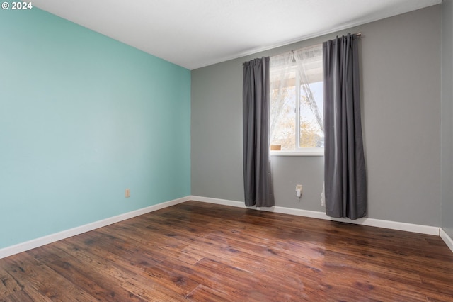 empty room featuring dark wood-type flooring