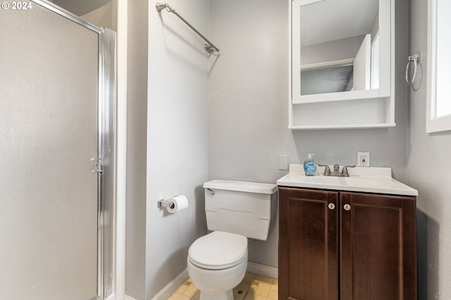 bathroom featuring vanity, an enclosed shower, and toilet