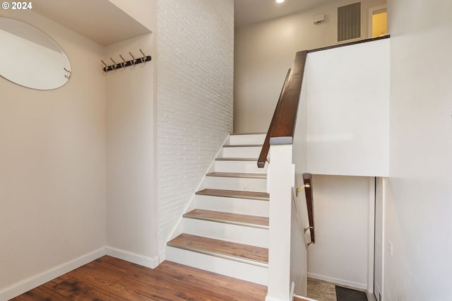 staircase with hardwood / wood-style flooring