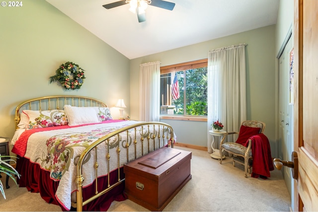 bedroom featuring light carpet, vaulted ceiling, and ceiling fan