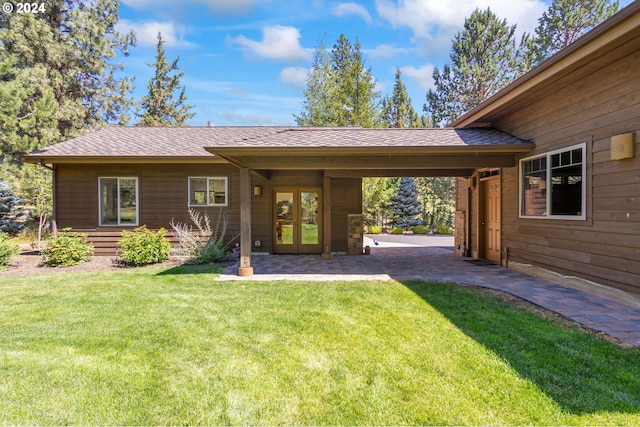 back of house with a yard and french doors