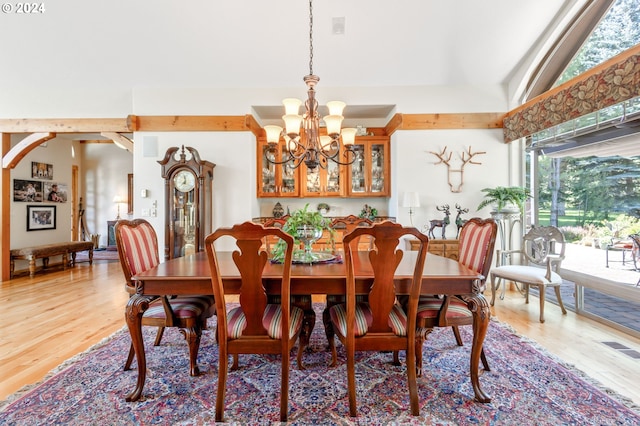 dining space with hardwood / wood-style flooring and a notable chandelier