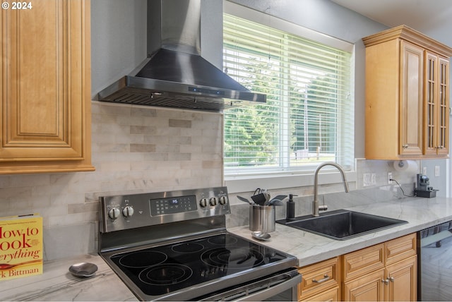 kitchen featuring decorative backsplash, wall chimney exhaust hood, black dishwasher, sink, and stainless steel range with electric cooktop