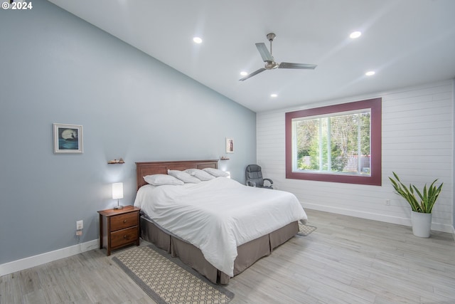 bedroom featuring light hardwood / wood-style flooring, vaulted ceiling, and ceiling fan