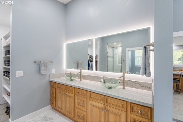 bathroom featuring vanity and a shower with door