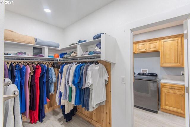 walk in closet featuring light hardwood / wood-style floors and washer / clothes dryer