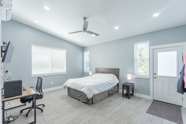 bedroom featuring ceiling fan, vaulted ceiling, and light hardwood / wood-style floors