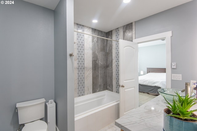 full bathroom featuring independent shower and bath, sink, hardwood / wood-style flooring, and toilet