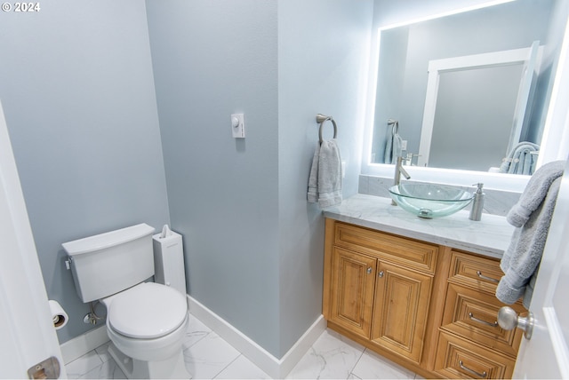 bathroom featuring toilet and vanity