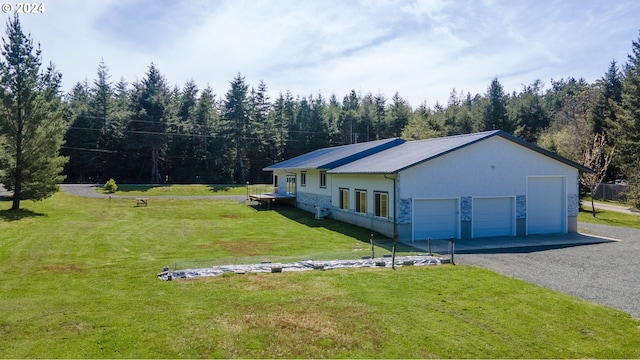 view of side of property featuring a yard and a garage