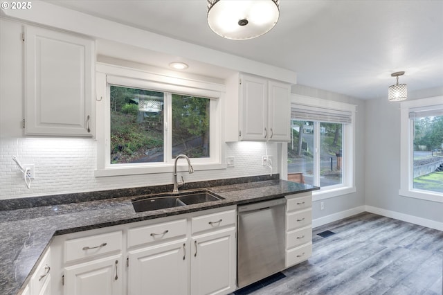 kitchen featuring stainless steel dishwasher, pendant lighting, white cabinetry, and sink