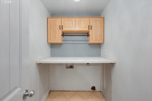 laundry room featuring washer hookup, light tile patterned flooring, and cabinets