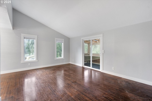 unfurnished room with hardwood / wood-style floors and lofted ceiling