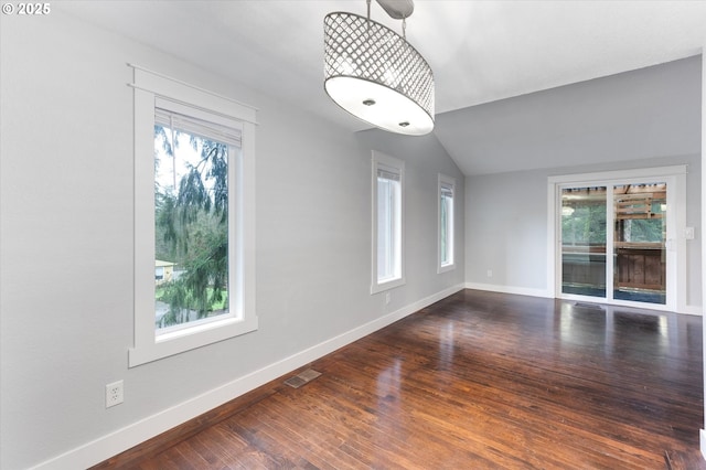 interior space featuring dark hardwood / wood-style flooring and vaulted ceiling