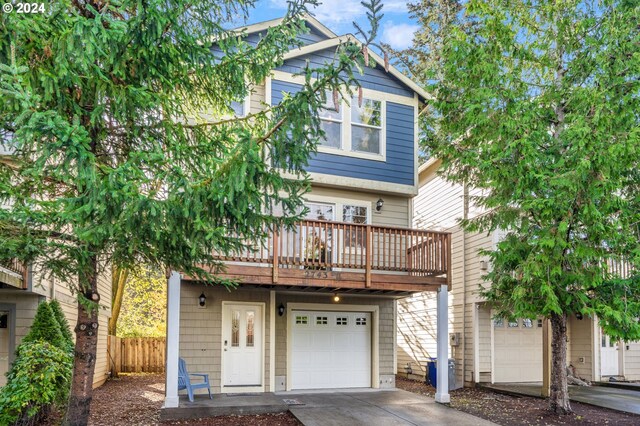 view of front of property featuring a balcony and a garage