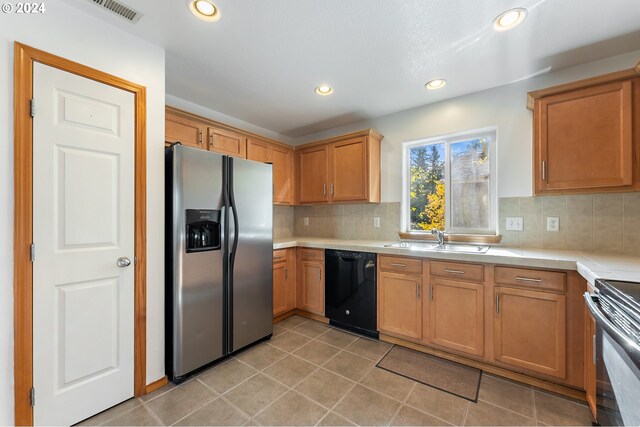 kitchen with black appliances, light tile patterned flooring, sink, and backsplash