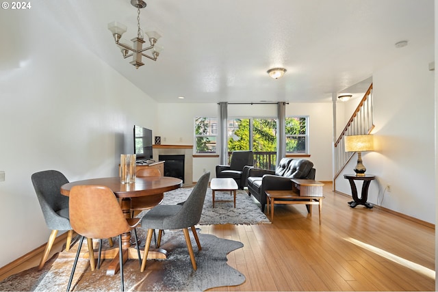 dining area featuring a chandelier and light wood-type flooring