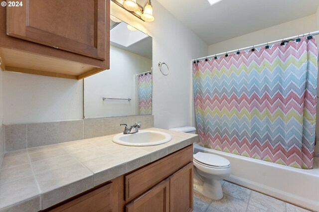 bathroom with vanity and brick wall