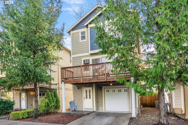 view of front of home with a garage, a wooden deck, and central AC