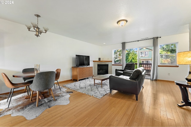 living room featuring a chandelier and light hardwood / wood-style floors