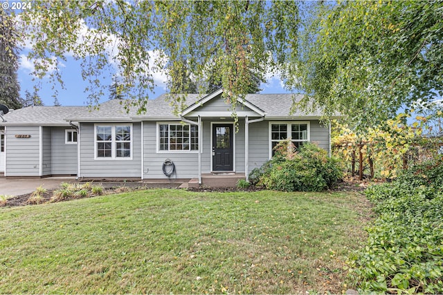 single story home with a garage and a front lawn