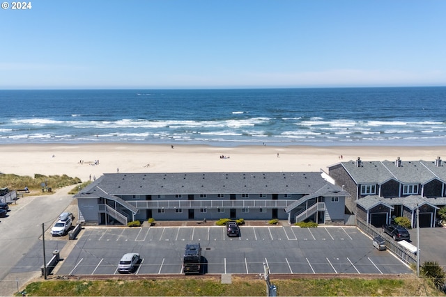 bird's eye view featuring a water view and a beach view