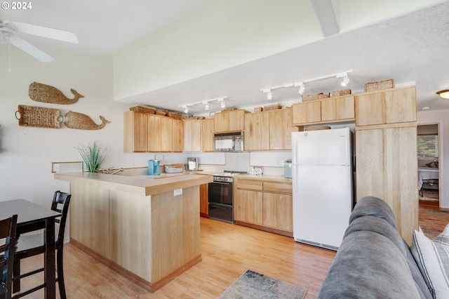 kitchen featuring light brown cabinets, stove, light wood-type flooring, white fridge, and kitchen peninsula