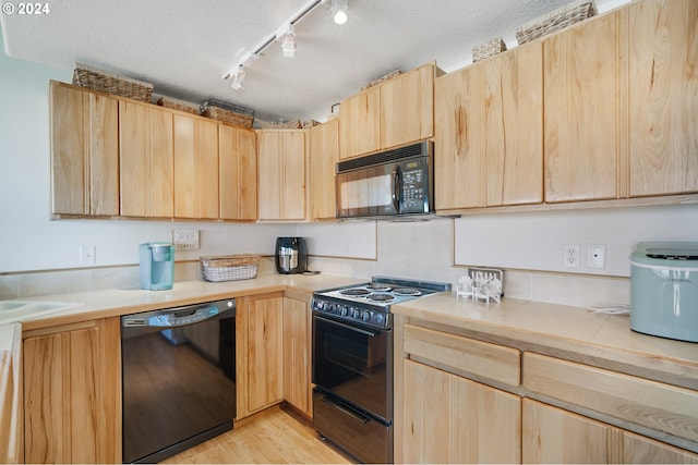 kitchen featuring black appliances, a textured ceiling, light brown cabinetry, and light hardwood / wood-style flooring