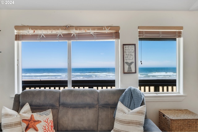 living room with a water view and a beach view