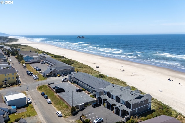 drone / aerial view featuring a water view and a beach view