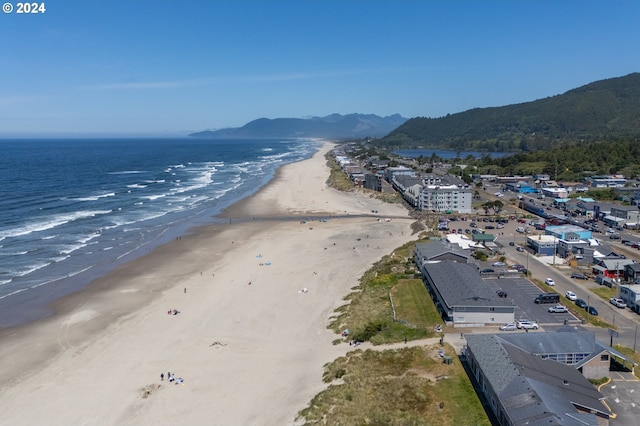 bird's eye view featuring a view of the beach and a water and mountain view