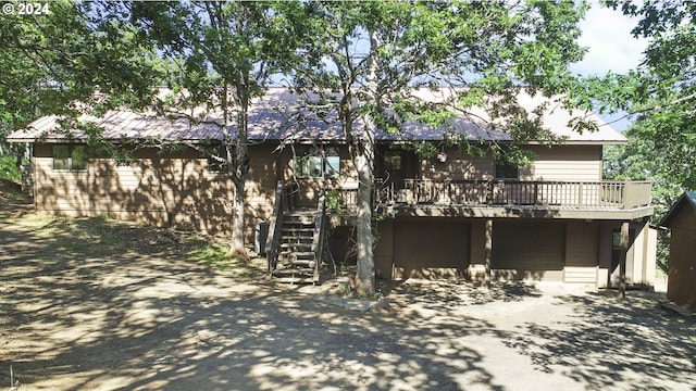 exterior space featuring a garage and a wooden deck