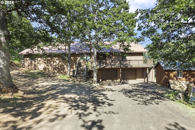 obstructed view of property with a shed and a deck