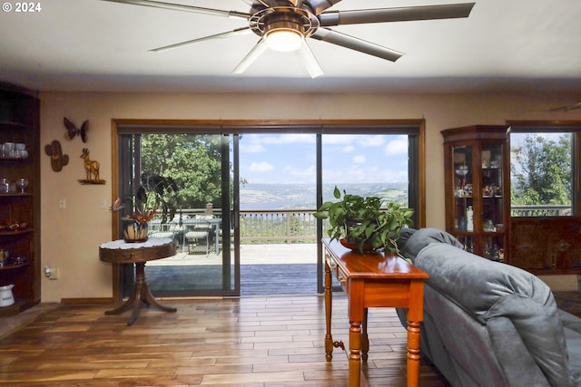 living room with a mountain view, hardwood / wood-style flooring, and plenty of natural light