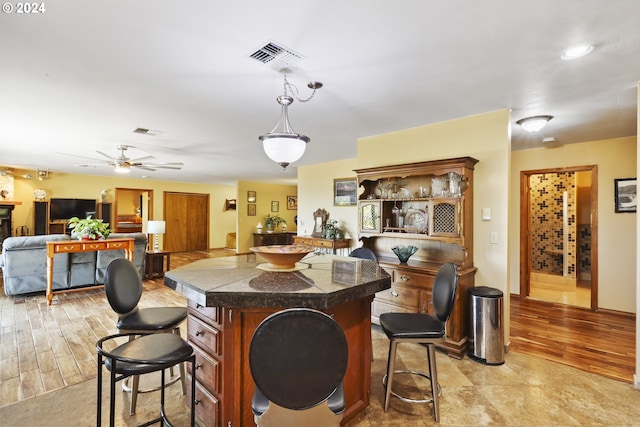 interior space featuring pendant lighting, ceiling fan, and light hardwood / wood-style flooring