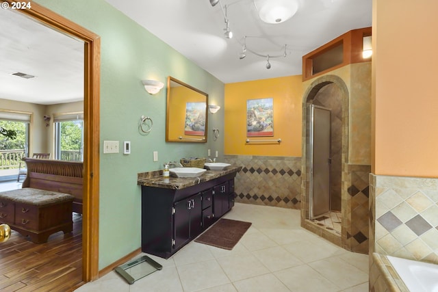 bathroom with separate shower and tub, hardwood / wood-style floors, vanity, and tile walls