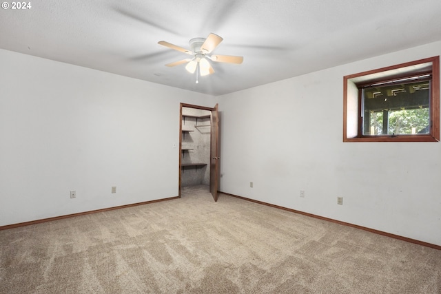 unfurnished room featuring light colored carpet and ceiling fan