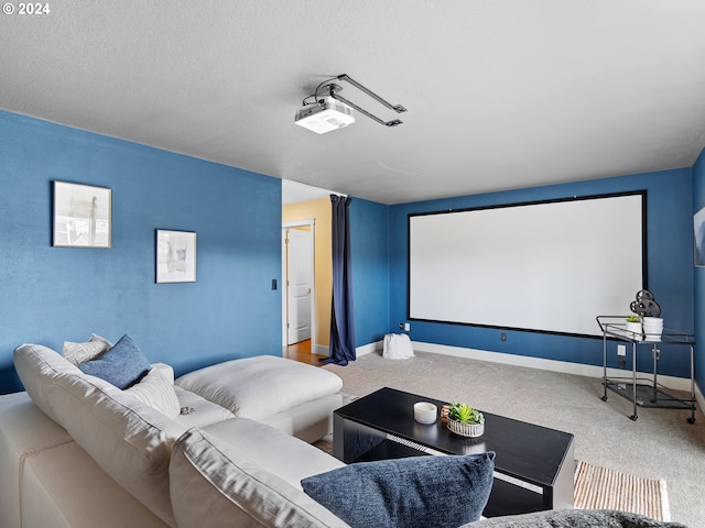 carpeted cinema room featuring a textured ceiling