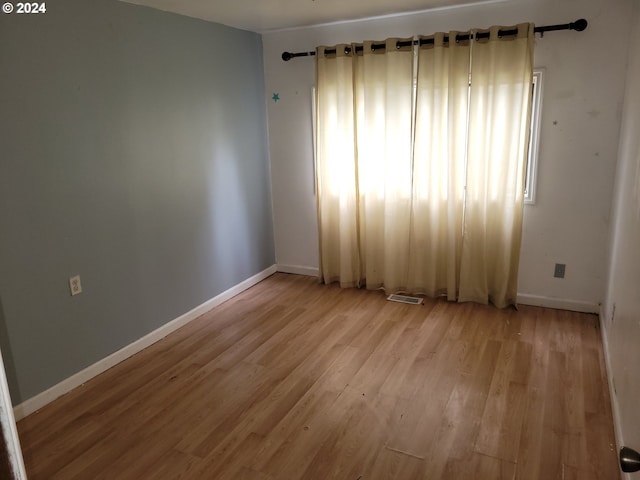 spare room featuring light hardwood / wood-style flooring